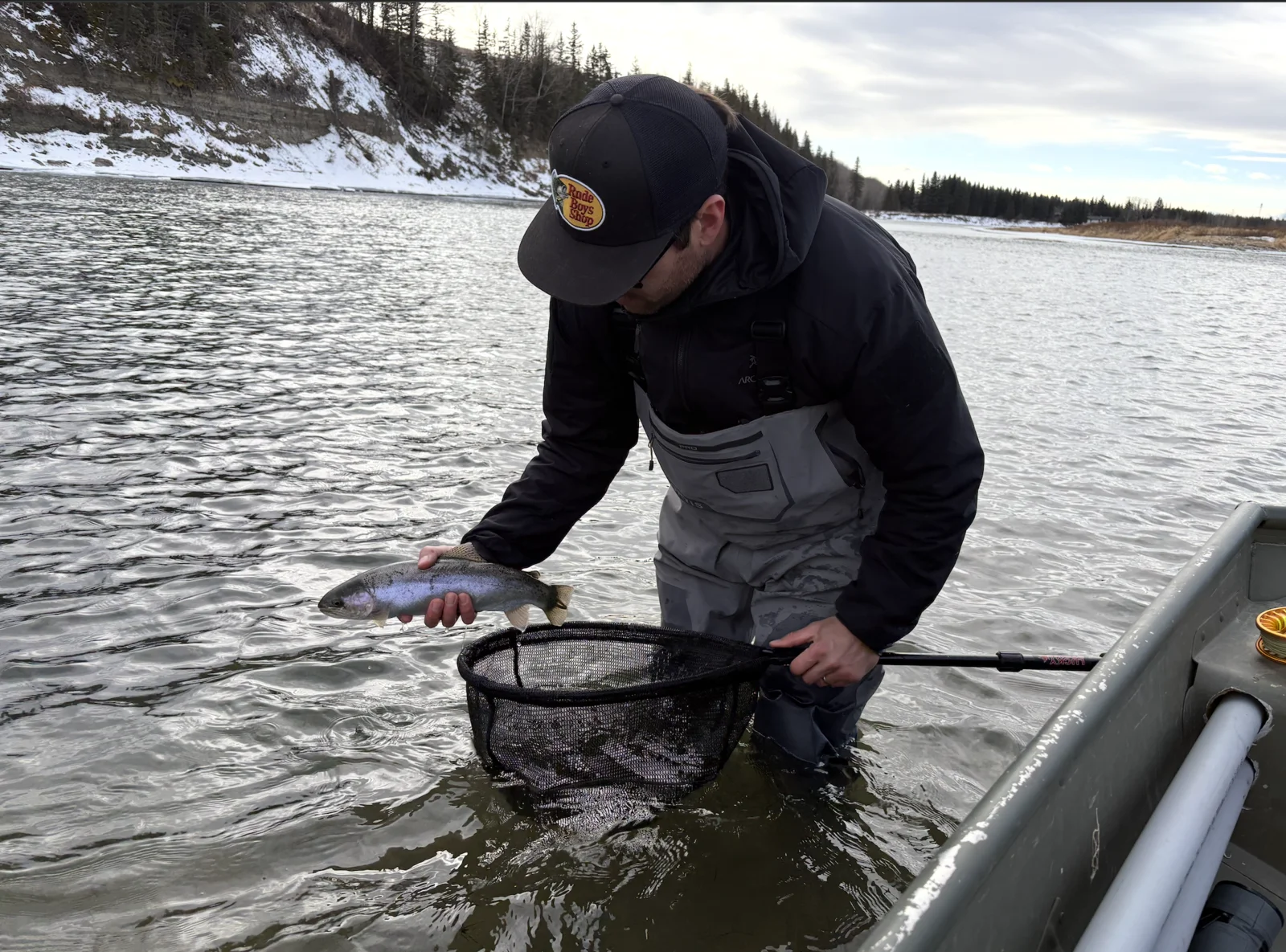 Client fighting a large trout on a guided fly fishing trip on the Bow River