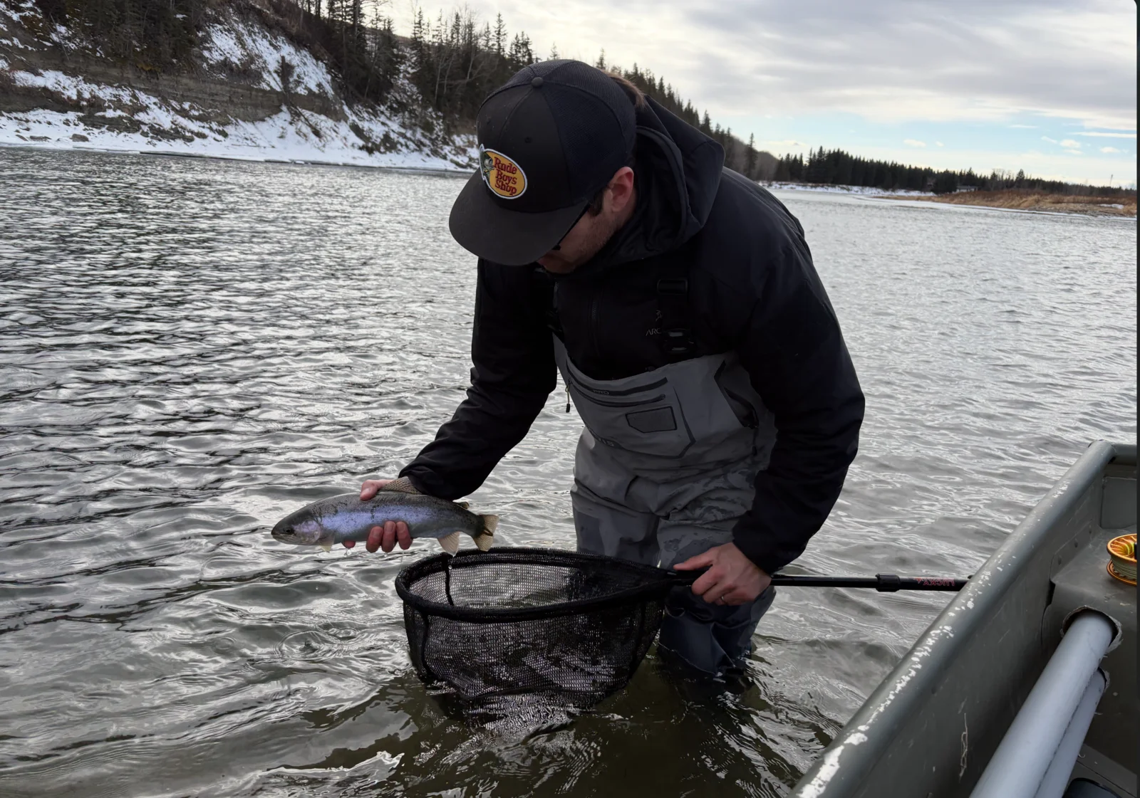 Guide holding a trophy rainbow trout caught on a guided fishing trip near Calgary