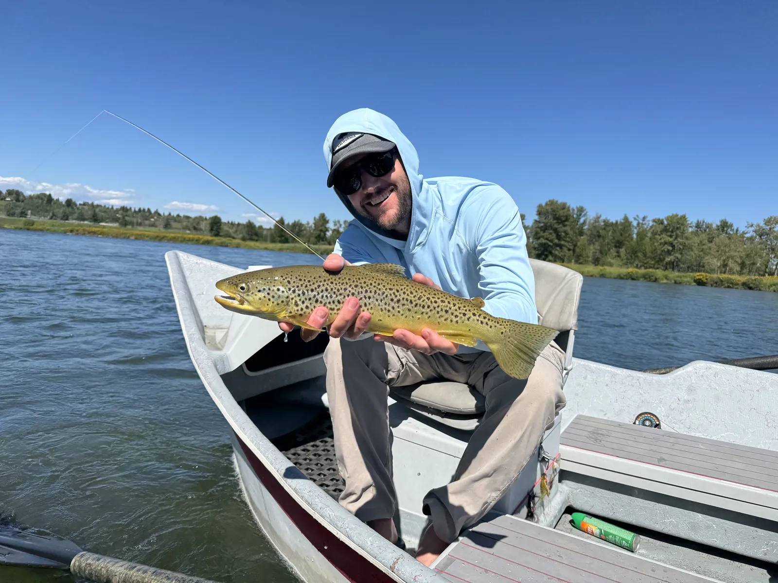 Happy client with trophy trout caught on guided Bow River fishing trip