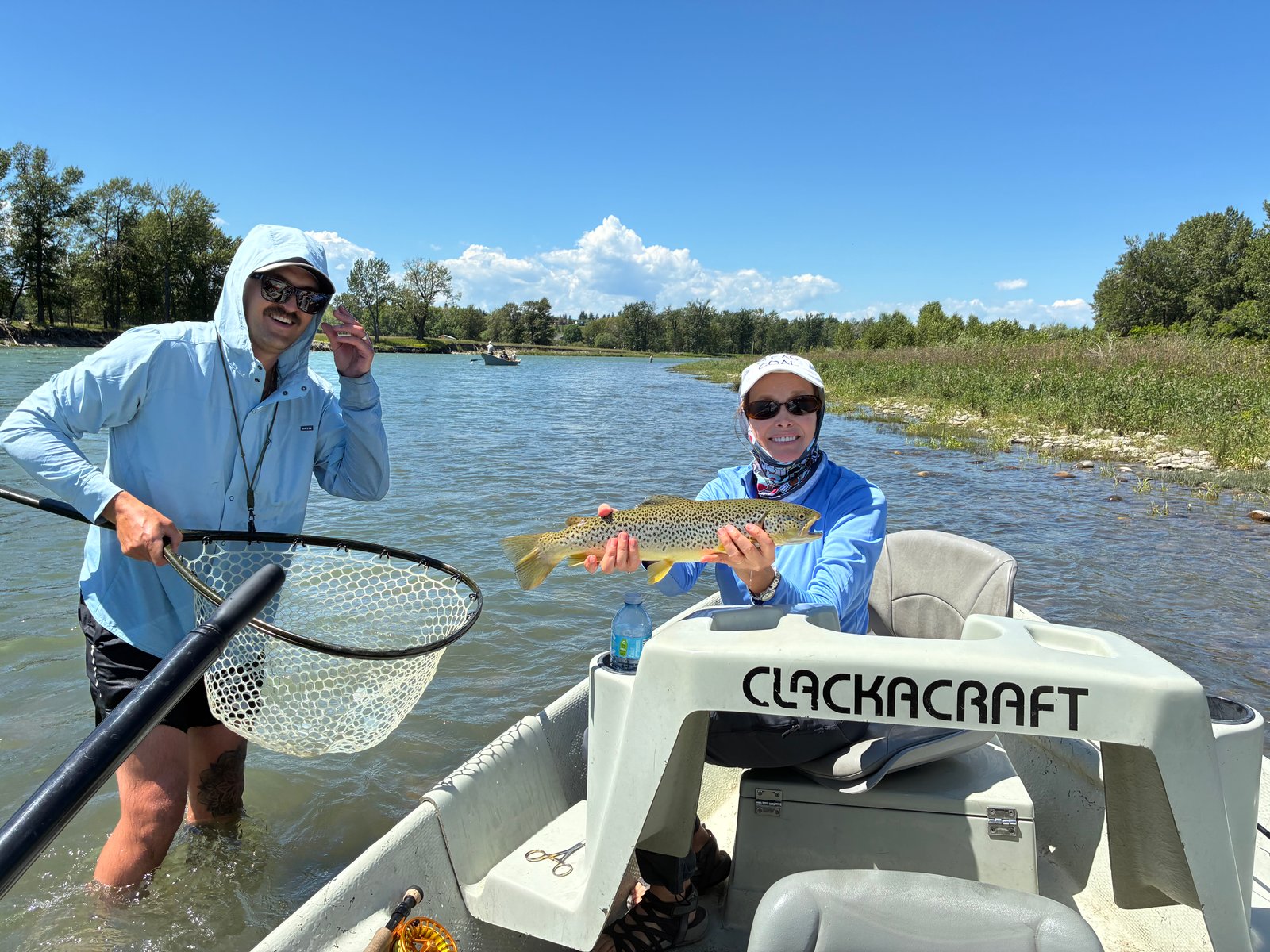 King Trout Outfitters - Happy clients with successful brown trout catch on Calgary waters